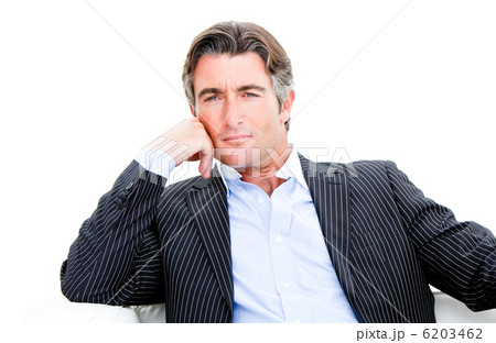Attractive businessman looking at the camera against white backg Attractive businessman looking at the camera against white backg 6203462