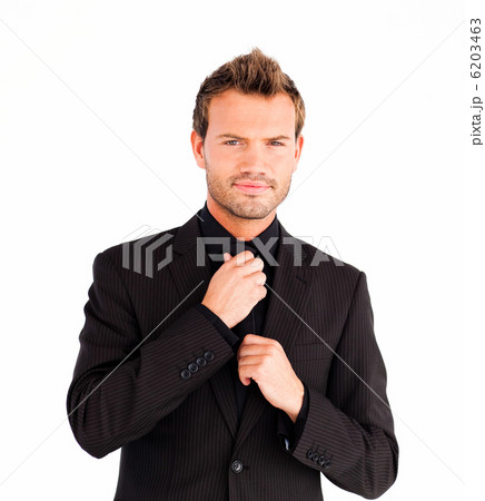 Businessman corrects a tie 6203463