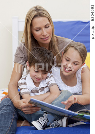 Mother reading a book with her daughter and son Mother reading a book with her daughter and son 6204693