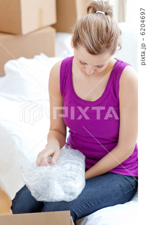 Beautiful woman unpacking box 6204697