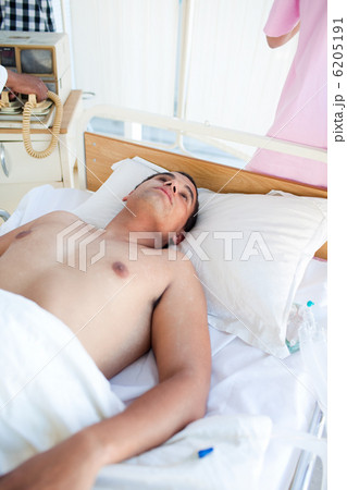 Barechested patient lying on a hospital bed Barechested patient lying on a hospital bed 6205191