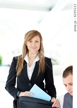 Beautiful businesswoman preparing her briefcase 6205222
