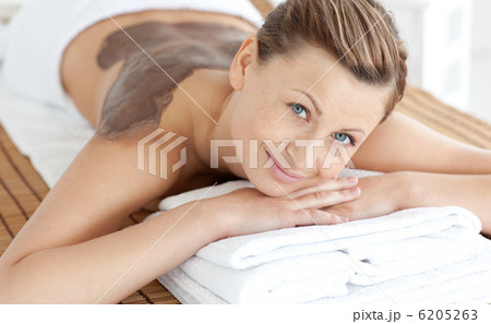 Beautiful woman enjoying a mud skin treatment 6205263