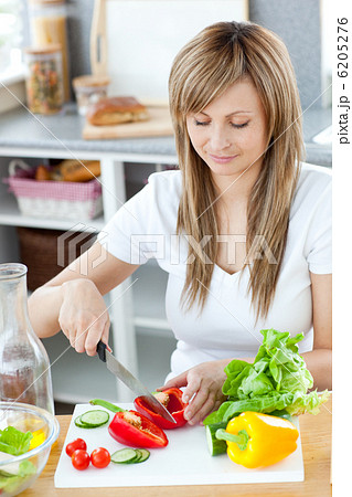 Delighted woman preparing a meal in the kitchen 6205276