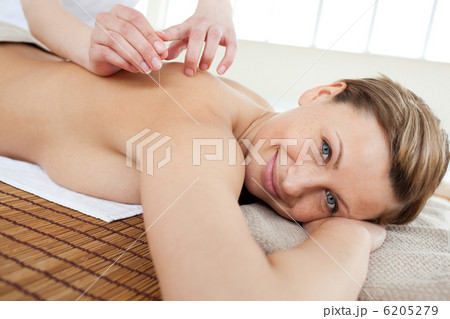 Portrait of a smiling woman in acupuncture therapy 6205279