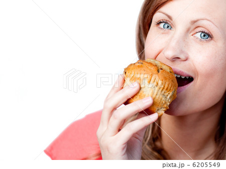 Caucasian woman is eating a muffin 6205549