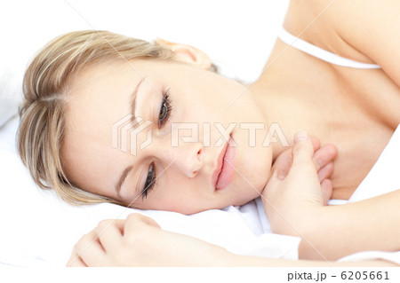 Radiant woman relaxing lying on her bed 6205661