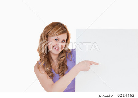 Cute blond-haired woman holding a white board Cute blond-haired woman holding a white board 6214462