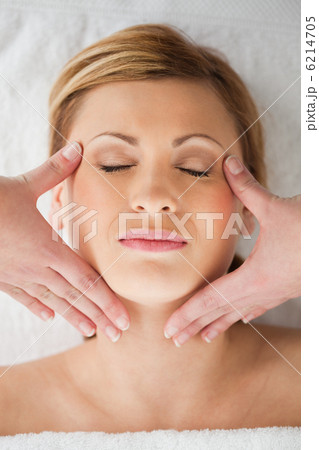 Attractive blond-haired woman getting a massage on her face Attractive blond-haired woman getting a massage on her face 6214705