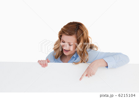 Attractive blond-haired woman standing behind a white board 6215104