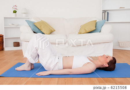 Gorgeous red-haired female stretching in the living room Gorgeous red-haired female stretching in the living room 6215508