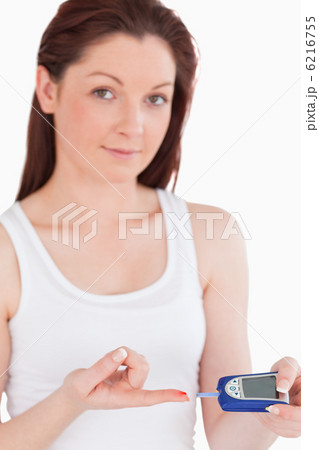 Cute woman testing her blood 6216755