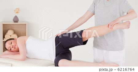 Sportswoman having a leg and hips stretching Sportswoman having a leg and hips stretching 6216764
