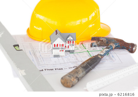 Top view of toy house model with hammer and helmet on a plan Top view of toy house model with hammer and helmet on a plan 6216816