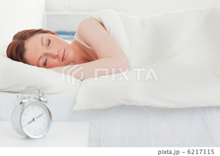 Beautiful red-haired woman sleeping in her bed 6217115