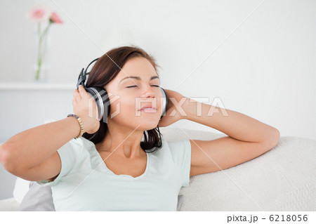 Charming dark-haired woman listening to music 6218056
