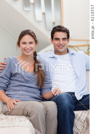 Portrait of a couple sitting on a sofa 6218557
