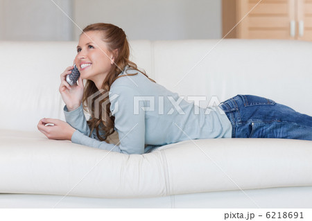 Young woman on the sofa having a nice conversation on the phone 6218691