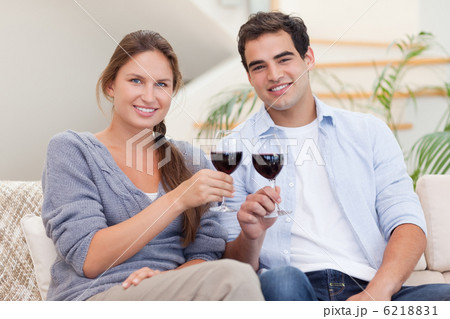 Young couple having a glass of red wine Young couple having a glass of red wine 6218831