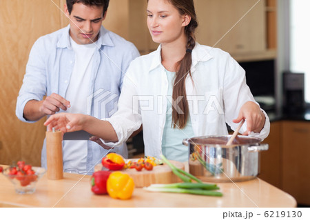 Cute couple using a tablet computer to cook Cute couple using a tablet computer to cook 6219130