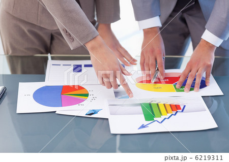 Hands of business people studying statistics 6219311