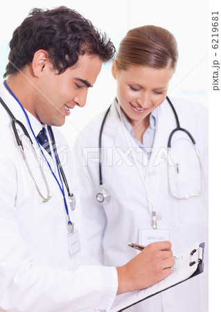 Assistant doctors taking notes Assistant doctors taking notes 6219681