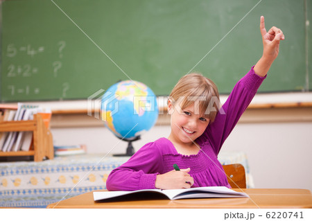 Schoolgirl raising her hand to ask a question 6220741