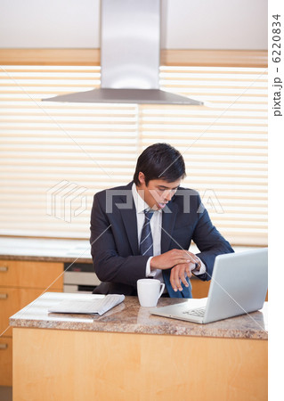 Portrait of a businessman running late 6220834