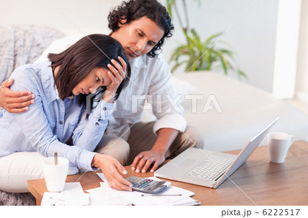 Side view of couple having a hard time paying their bills 6222517