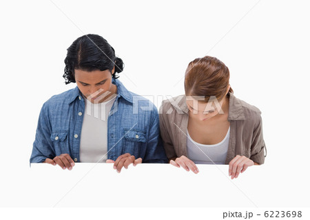 Couple looking down on blank wall 6223698