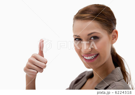 Side view of smiling woman giving thumb up Side view of smiling woman giving thumb up 6224318