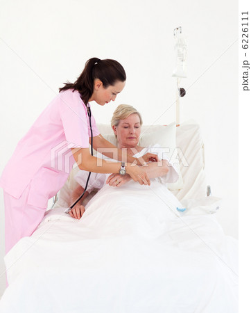 Confident doctor checking the pulse of a patient Confident doctor checking the pulse of a patient 6226111