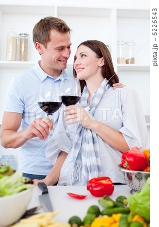 Affectionate couple drinking wine while cooking Affectionate couple drinking wine while cooking 6226543