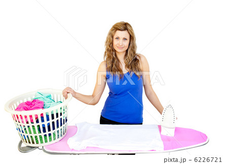 Unhappy woman with clothes behind ironing board 6226721
