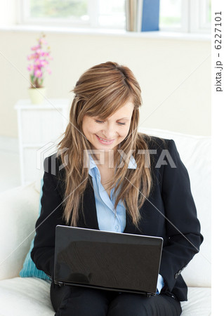Charming businesswoman using her laptop Charming businesswoman using her laptop 6227101