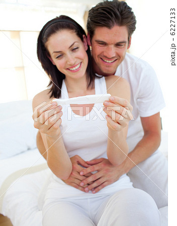 Smiling couple finding out results of a pregnancy test Smiling couple finding out results of a pregnancy test 6227133