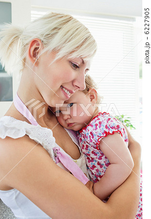 Smiling mother playing with her daughter Smiling mother playing with her daughter 6227905