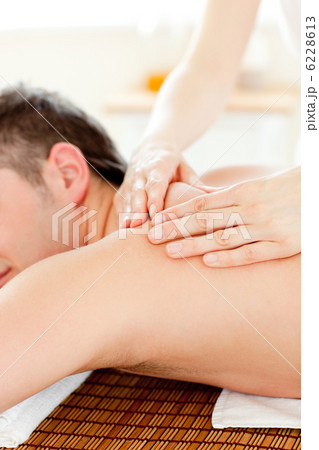 Caucasian young man enjoying a back massage Caucasian young man enjoying a back massage 6228613