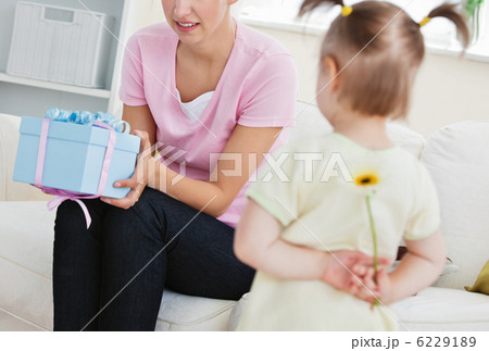 Surprised mother getting a present from her little daughter 6229189