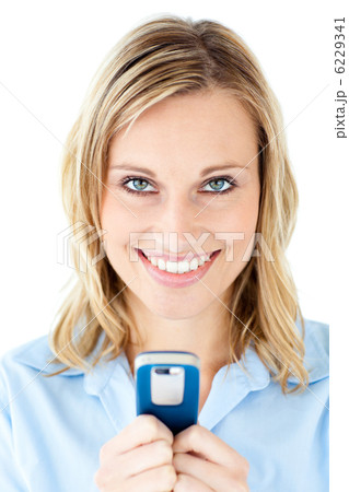 Happy young woman writing a message on her cellphone 6229341