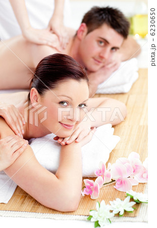 Merry young couple enjoying a back massage Merry young couple enjoying a back massage 6230650