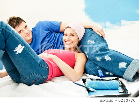 Happy young couple relaxing after painting a room 6230776