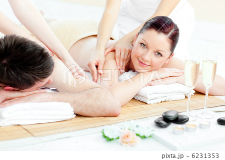 Charming young couple enjoying a back massage Charming young couple enjoying a back massage 6231353
