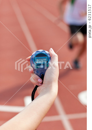 Close-up of a woman holding a chronometer to measure performance Close-up of a woman holding a chronometer to measure performance 6231517