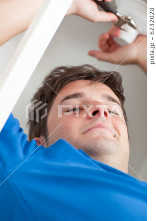 Self-assured man repairing his sink in the kitchen Self-assured man repairing his sink in the kitchen 6232028