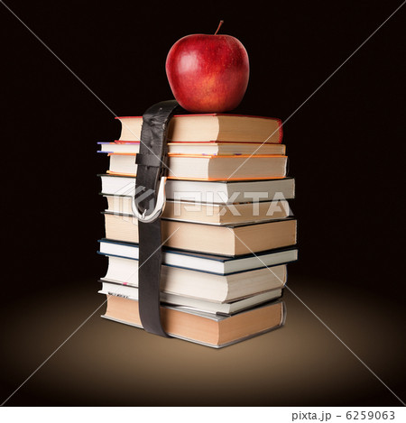 books pile with belt and apple books pile with belt and apple 6259063