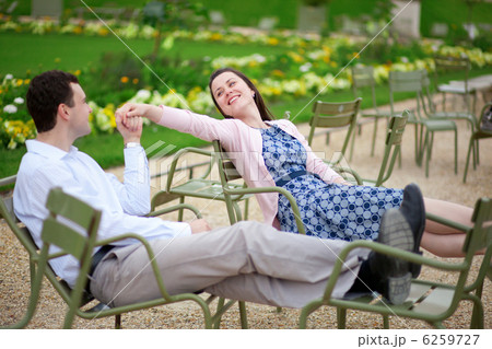 Romantic couple sitting on chairs in Luxembourg garden of Paris 6259727
