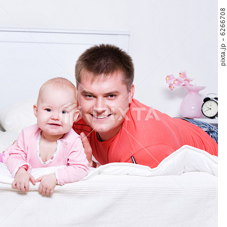 young father with smiling baby lying young father with smiling baby lying 6266708