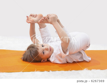Children's yoga. The little boy does exercise. Children's yoga. The little boy does exercise. 6267369