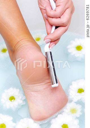 woman scrubbing foot  in water 6269781